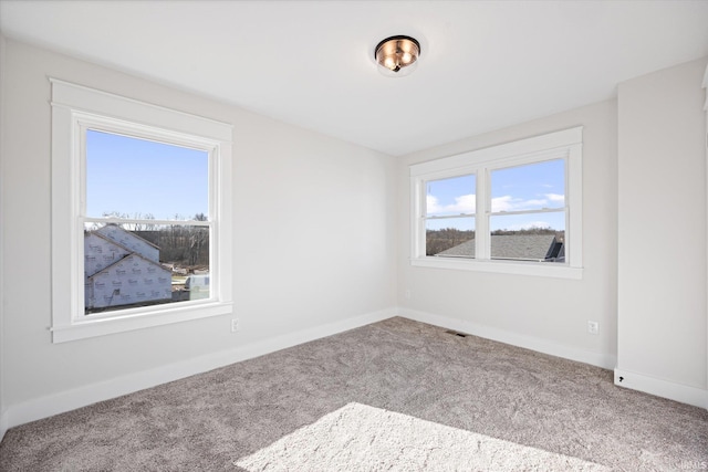 carpeted spare room with plenty of natural light