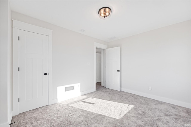 unfurnished bedroom featuring light colored carpet