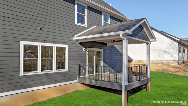 back of property with a lawn and ceiling fan