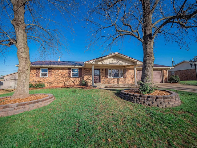 ranch-style house featuring a garage and a front lawn