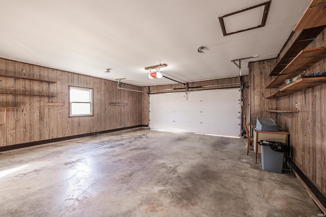 garage with wood walls and a garage door opener