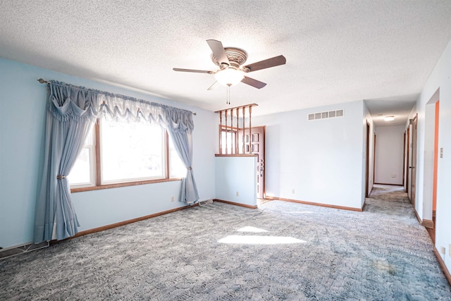 unfurnished room featuring carpet, ceiling fan, and a textured ceiling