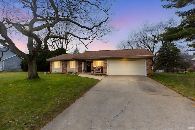 ranch-style home with a lawn and a garage