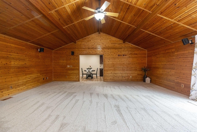 interior space with carpet flooring, wooden walls, and wooden ceiling