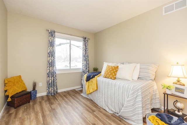 bedroom with hardwood / wood-style floors