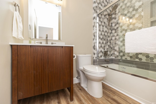 full bathroom with vanity, toilet, combined bath / shower with glass door, and wood-type flooring