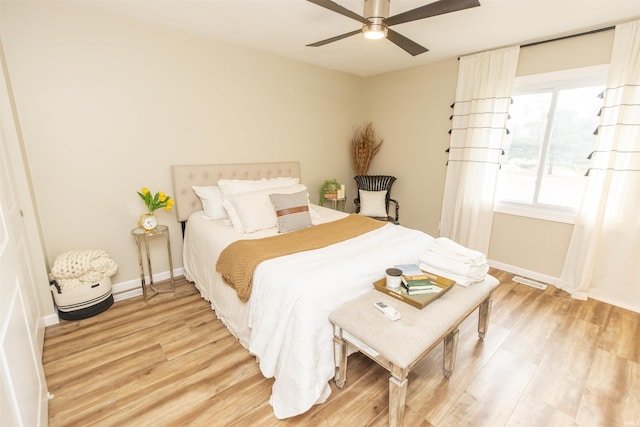 bedroom with hardwood / wood-style floors and ceiling fan