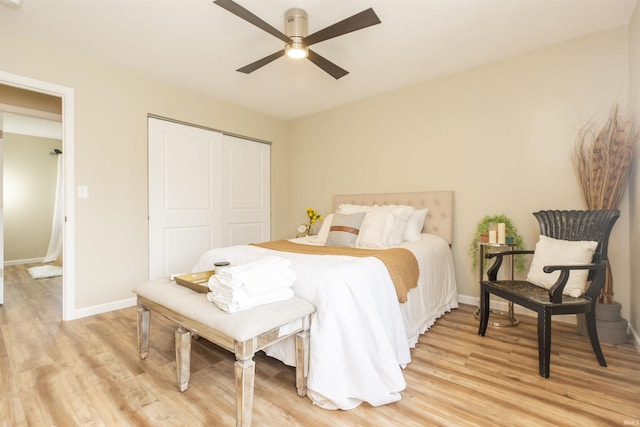 bedroom featuring a closet, light hardwood / wood-style floors, and ceiling fan