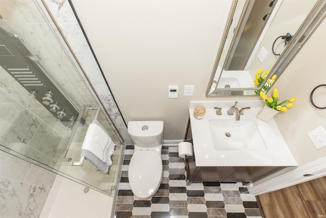 bathroom with vanity, toilet, and an enclosed shower