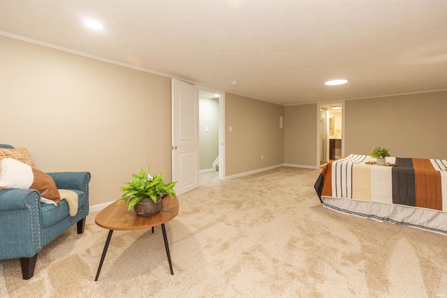 bedroom featuring ensuite bathroom and light colored carpet