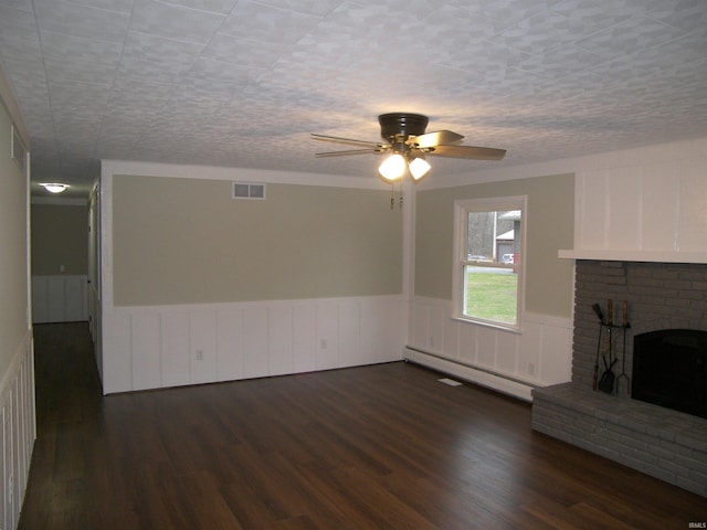 unfurnished living room with a fireplace, ceiling fan, baseboard heating, and dark wood-type flooring