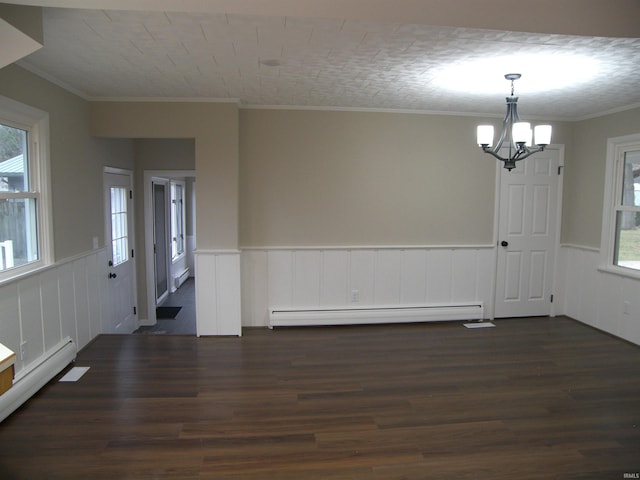 interior space with a chandelier, dark hardwood / wood-style flooring, ornamental molding, and a baseboard heating unit