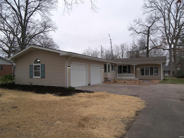 view of front of home featuring covered porch and a garage