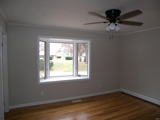 spare room with crown molding, ceiling fan, a baseboard heating unit, and hardwood / wood-style flooring