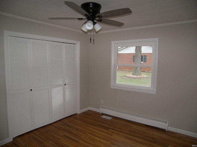 unfurnished bedroom featuring ornamental molding, ceiling fan, dark wood-type flooring, a baseboard radiator, and a closet