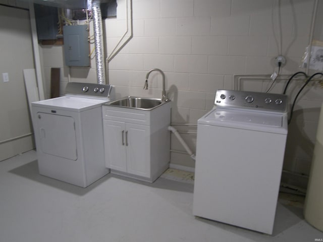 laundry room with separate washer and dryer, electric panel, and sink