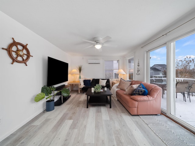 living room with light wood-type flooring, a wall mounted AC, and ceiling fan