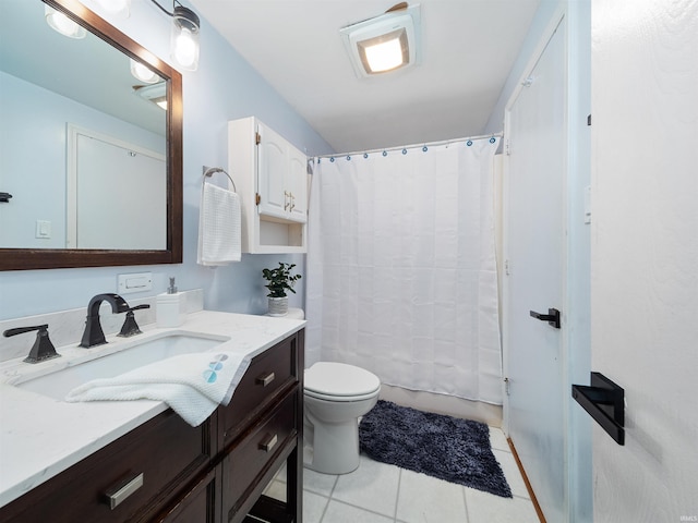 bathroom with toilet, vanity, tile patterned floors, and walk in shower