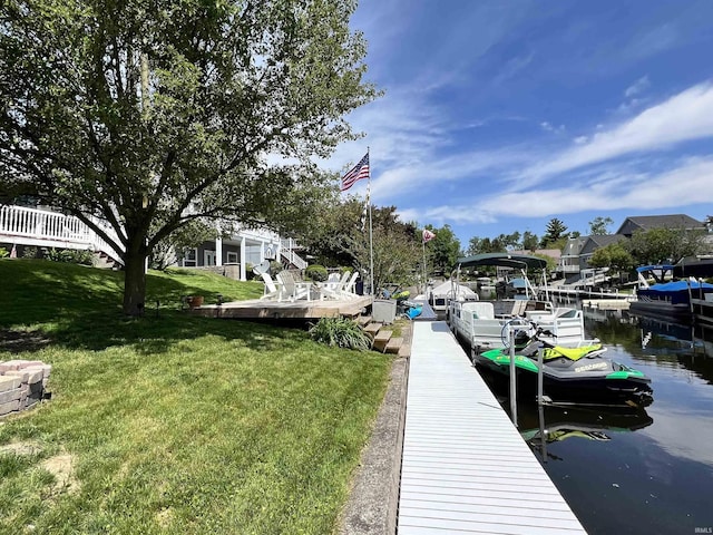 view of dock featuring a water view and a lawn