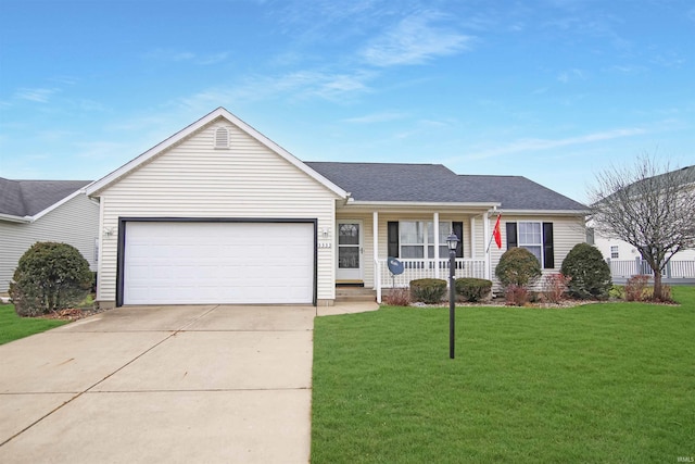 ranch-style house featuring covered porch, a garage, and a front lawn