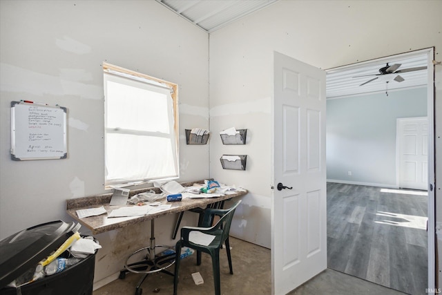 home office with ceiling fan and concrete floors