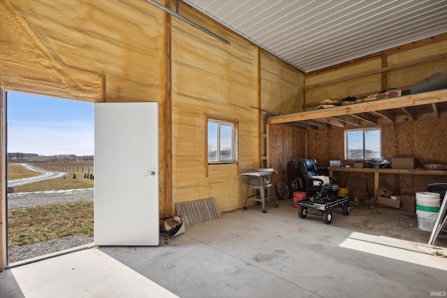 misc room with concrete floors and a rural view