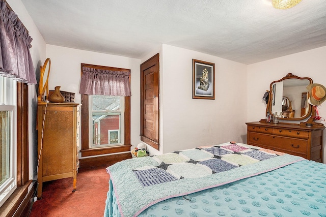 carpeted bedroom featuring a textured ceiling