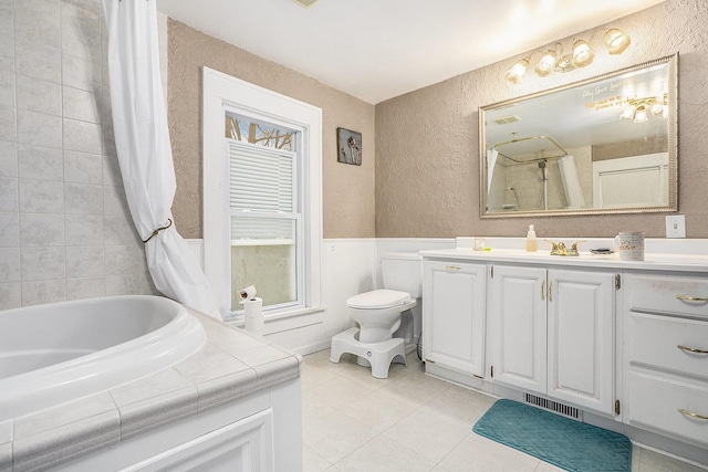 bathroom with tile patterned flooring, vanity, and toilet