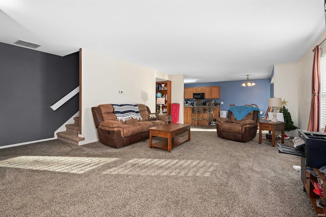 carpeted living room featuring a notable chandelier