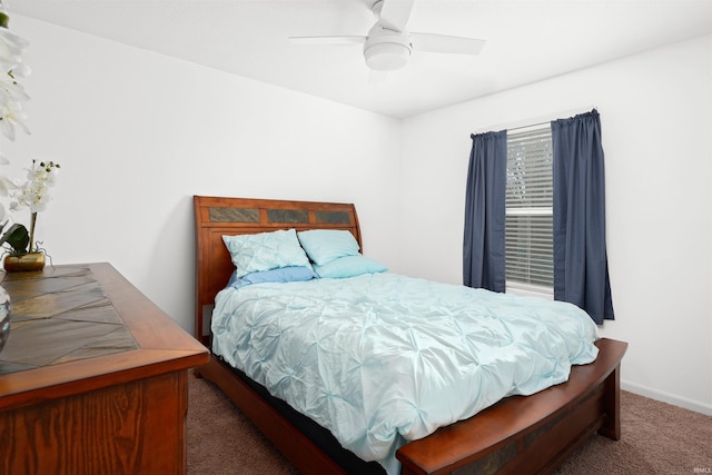 bedroom featuring dark colored carpet and ceiling fan