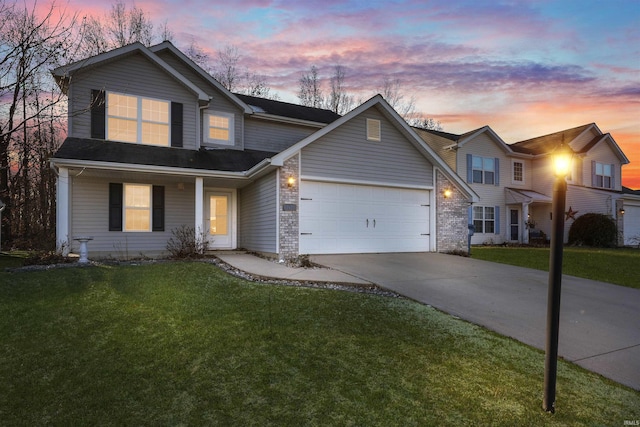 view of property featuring a lawn and a garage