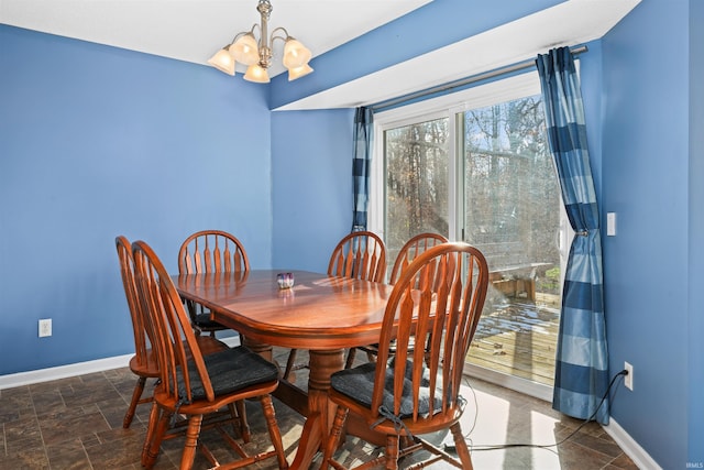 dining space with a notable chandelier