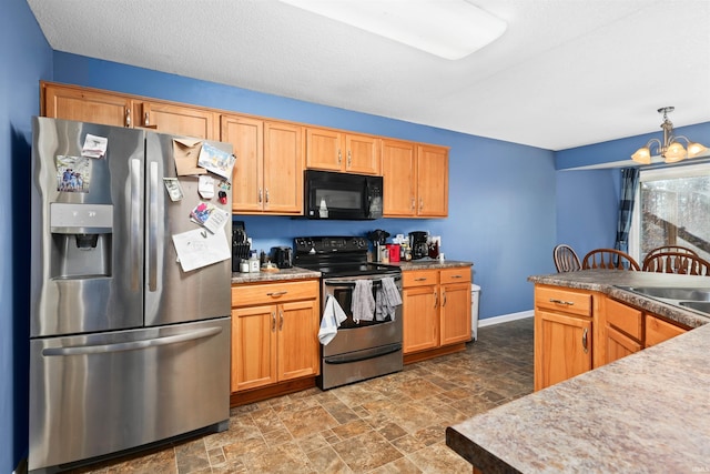 kitchen featuring a notable chandelier, decorative light fixtures, sink, and appliances with stainless steel finishes