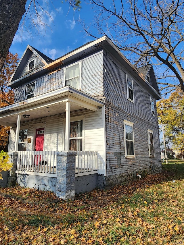 view of property exterior with covered porch