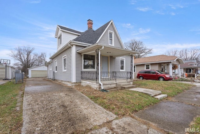 bungalow with an outbuilding, a porch, and a garage