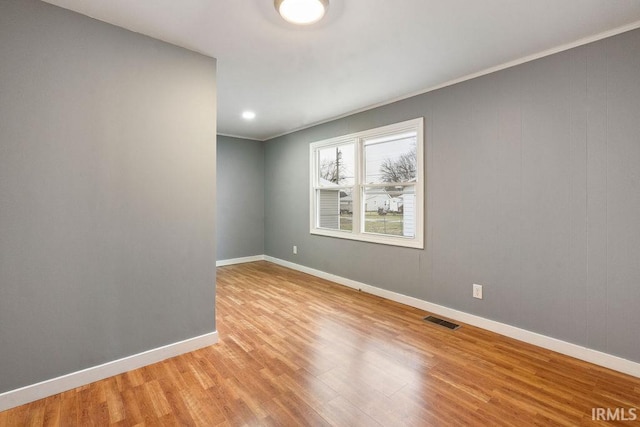 unfurnished room with light hardwood / wood-style floors and ornamental molding