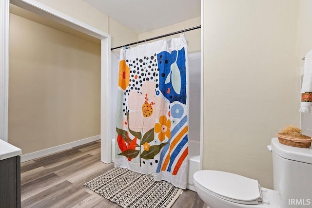 bathroom featuring hardwood / wood-style floors, shower / tub combo, and toilet