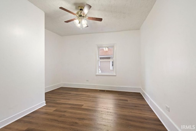 unfurnished room featuring ceiling fan, dark hardwood / wood-style flooring, and a textured ceiling