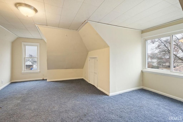 bonus room with plenty of natural light, carpet floors, and lofted ceiling