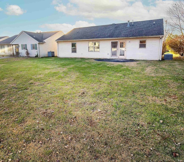 back of house with a lawn and central AC unit