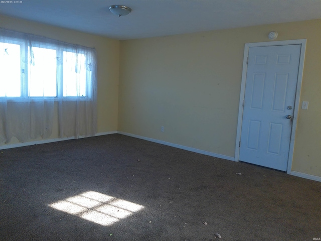 empty room with dark carpet