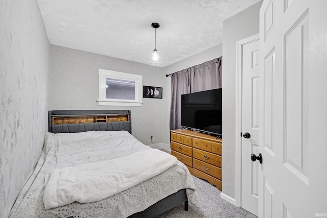 carpeted bedroom featuring a fireplace and a textured ceiling