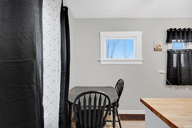 tiled dining room with a textured ceiling