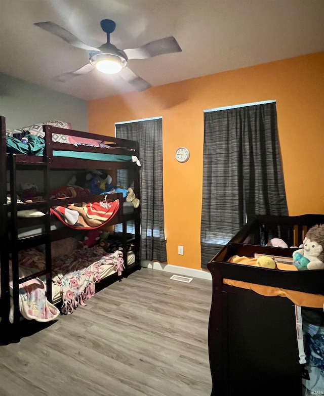 bedroom with hardwood / wood-style floors and ceiling fan