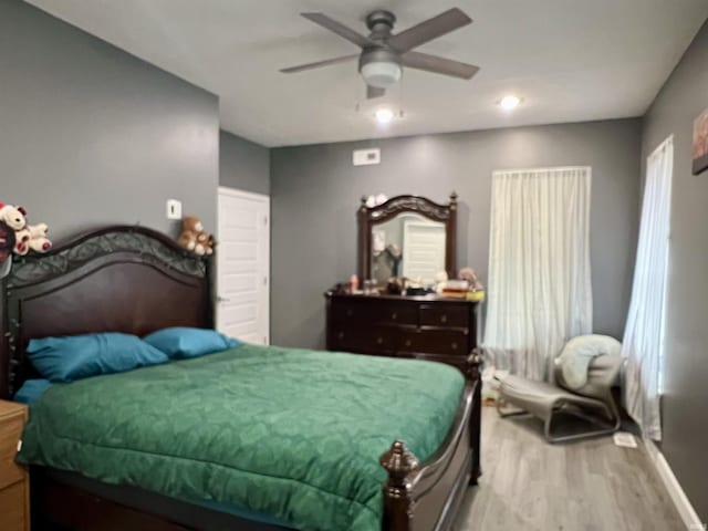 bedroom with hardwood / wood-style flooring and ceiling fan