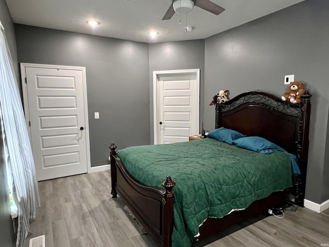 bedroom featuring ceiling fan and light hardwood / wood-style floors