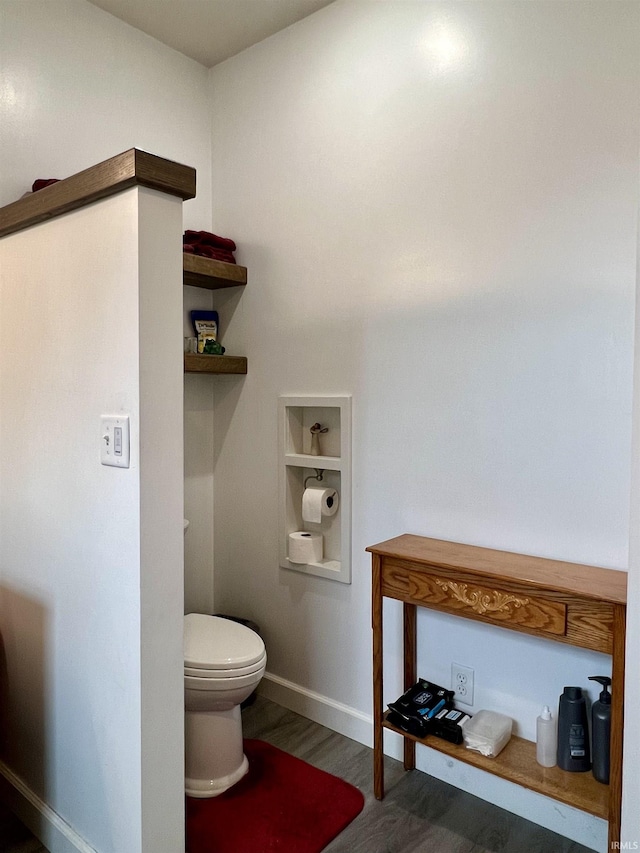 bathroom featuring hardwood / wood-style flooring and toilet