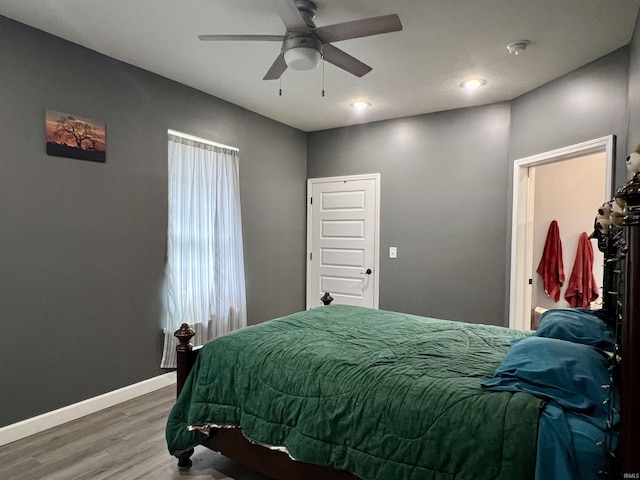 bedroom with ceiling fan and wood-type flooring