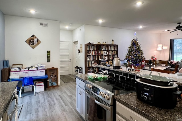 kitchen with white cabinets, ceiling fan, light hardwood / wood-style floors, and high end stainless steel range