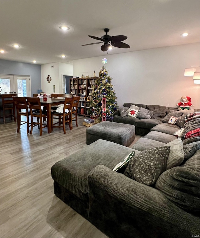 living room with ceiling fan and light wood-type flooring